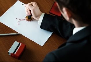 Professional sealing a document for birth certificate attestation – NRIWAY company services.